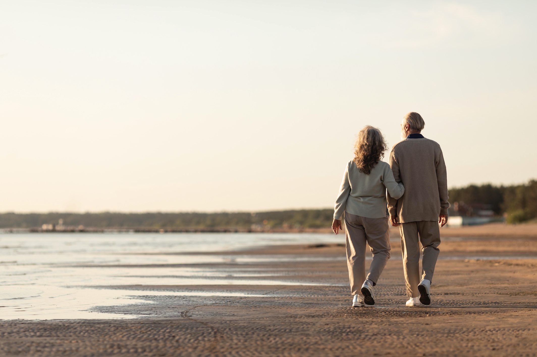 Older couple walking on beach.jpg